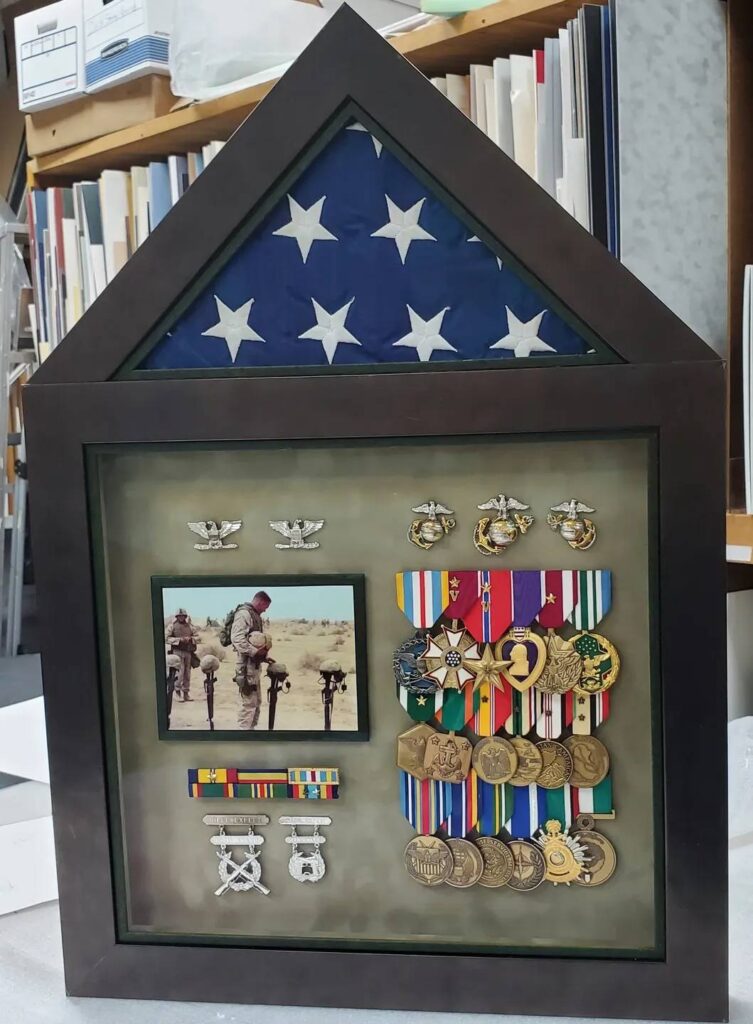 The Frame Shop A picture of medals and ribbons on display.