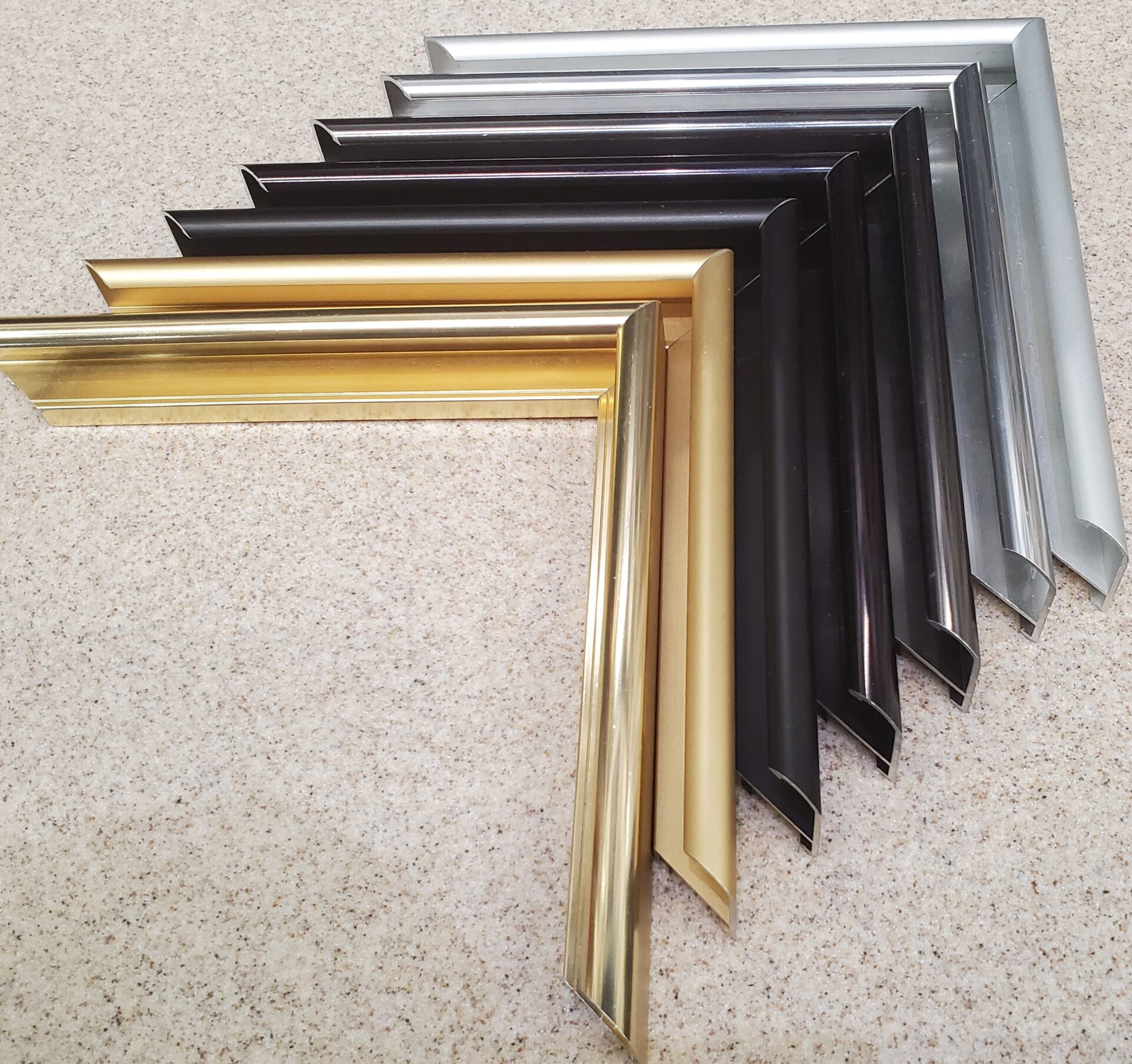 A group of different colored frames sitting on the floor.