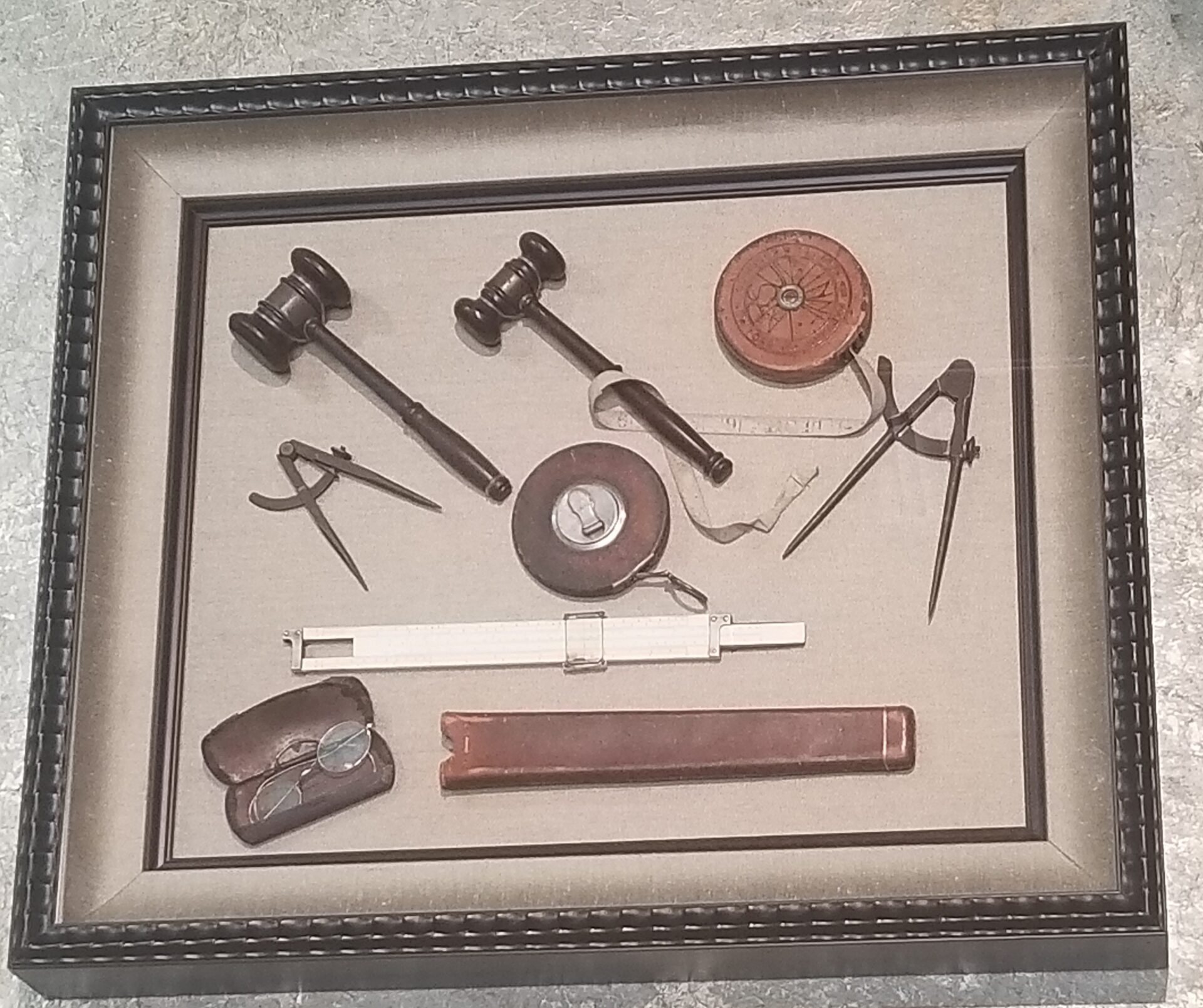 A framed picture of various tools and equipment.