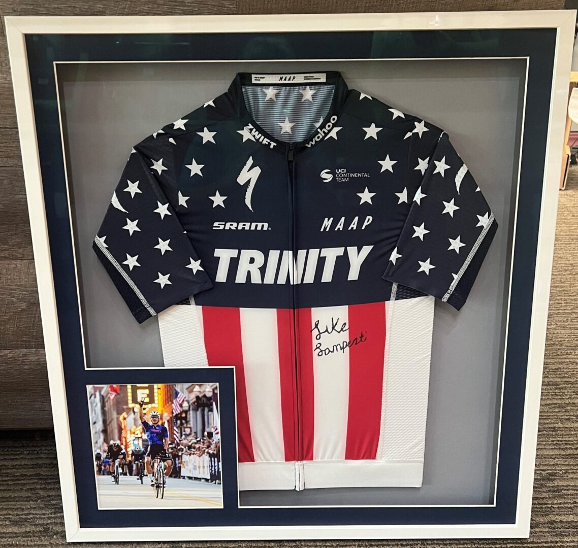 A framed jersey with an autographed picture of the cyclist.