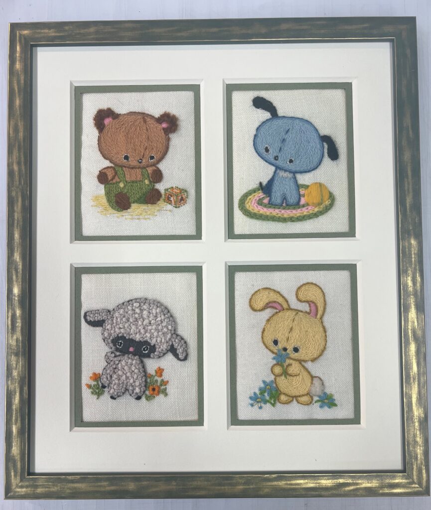 Animal Needlework Four different animals are framed in a frame.